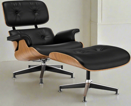 Black leather lounge chair and ottoman with wooden accents on a white background